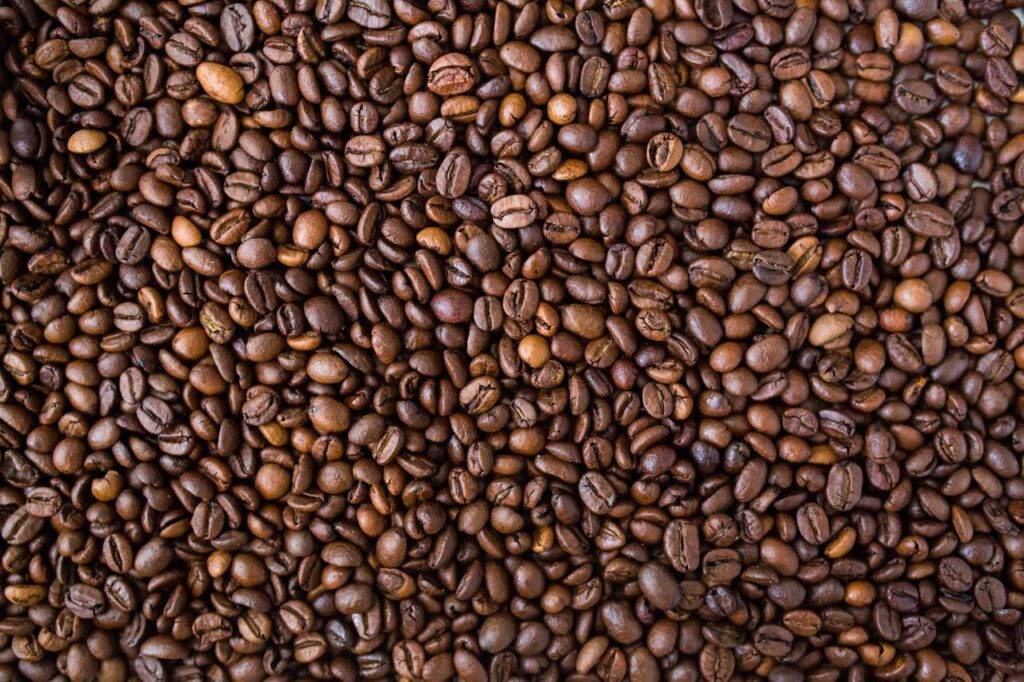 A detailed view of medium roast coffee beans, rich in texture and color.