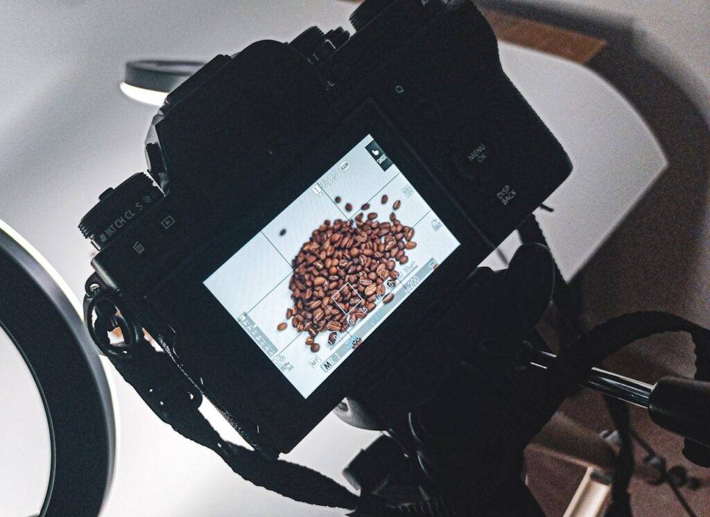 Close-up of a camera screen displaying a pile of coffee beans in a professional studio setup.