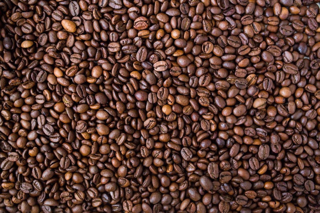 A detailed view of medium roast coffee beans, rich in texture and color.